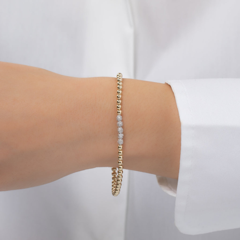 3mm Gold Bead Bracelet with diamond beads worn on wrist