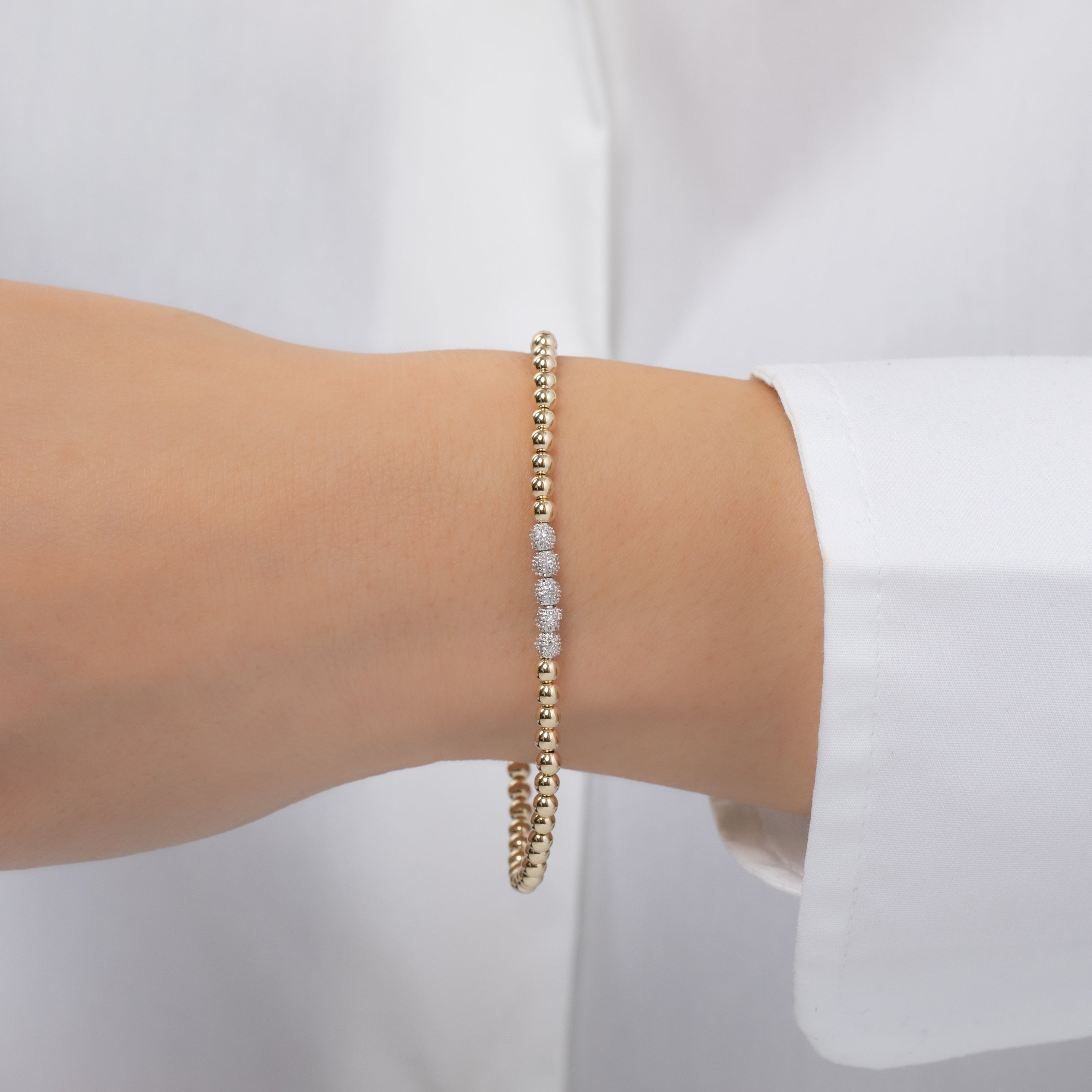 3mm Gold Bead Bracelet with diamond beads worn on wrist