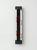 Back of black accessible mezuzah showing adhesive mounting strips by Oneg × TOM