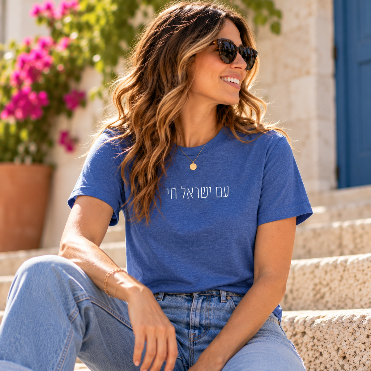 Woman wearing a blue Am Yisrael Chai T-shirt with white Hebrew lettering.