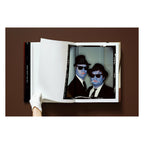 Annie Leibovitz photography book open to her portrait of Dan Aykroyd and John Belushi as the Blues Brothers