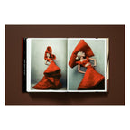 Annie Leibovitz photography book open to two 2011 portraits of Lady Gaga in a sculptural red gown