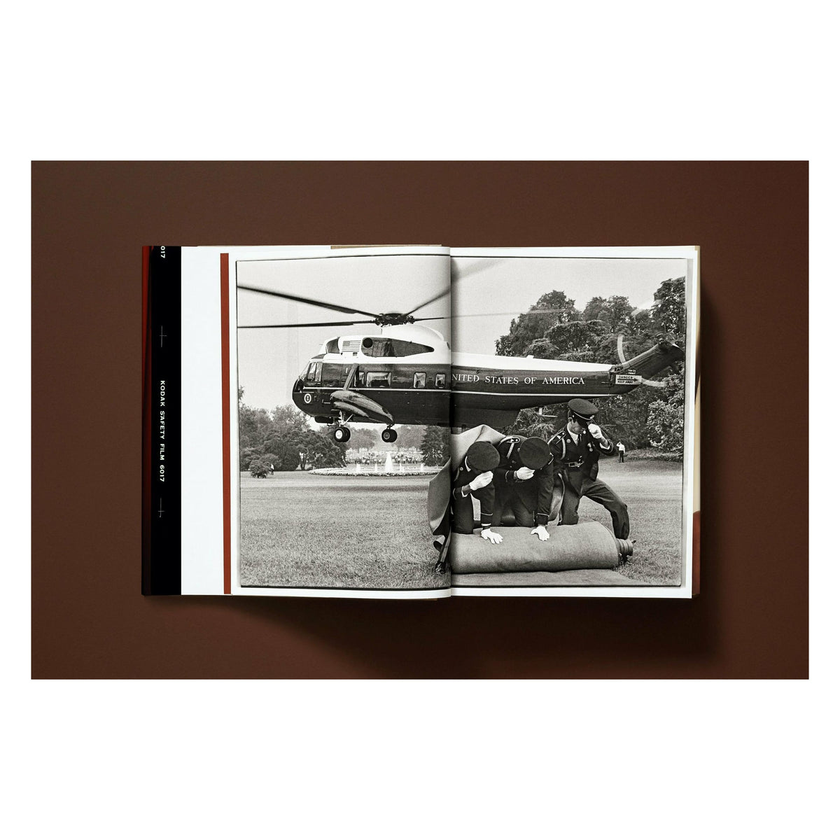 Annie Leibovitz photography book open to a black-and-white photograph of a presidential helicopter landing at the White House