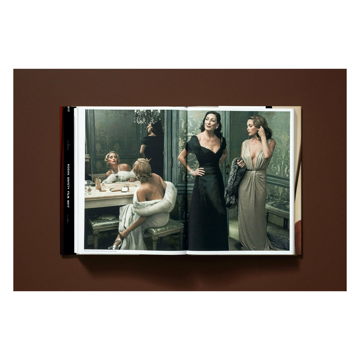 Annie Leibovitz photography book open to her 2006 portrait of Sharon Stone, Anjelica Huston, and Diane Lane