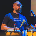Benji Rosenzweig performing on percussion in an Empowered Jews Empower Jews T-Shirt