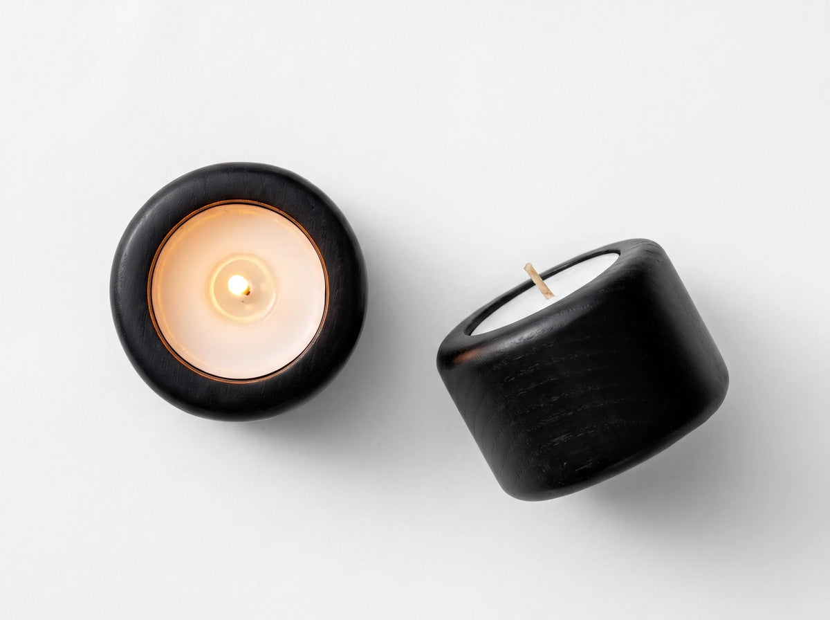 Black wood Shabbat tealight candleholders with lit tealight by Oneg