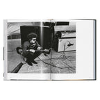 Daniel Kramer photograph of Bob Dylan with an electric guitar, harmonica and amplifiers