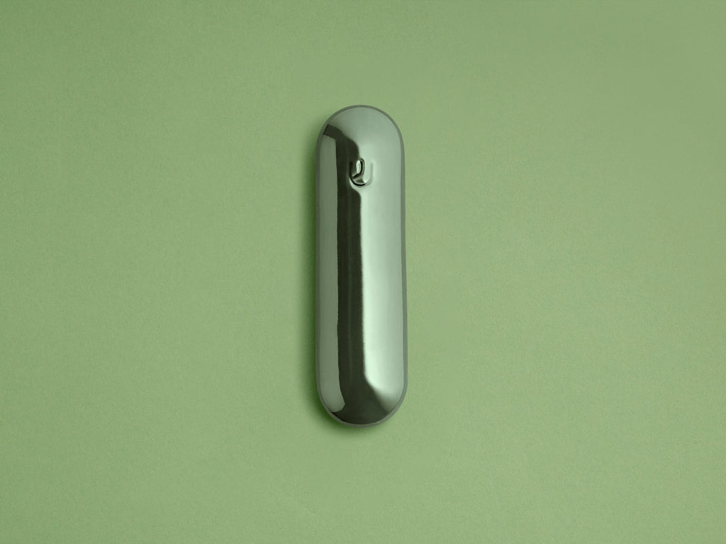 Fern Ceramic Pill Mezuzah shown upright against a green background