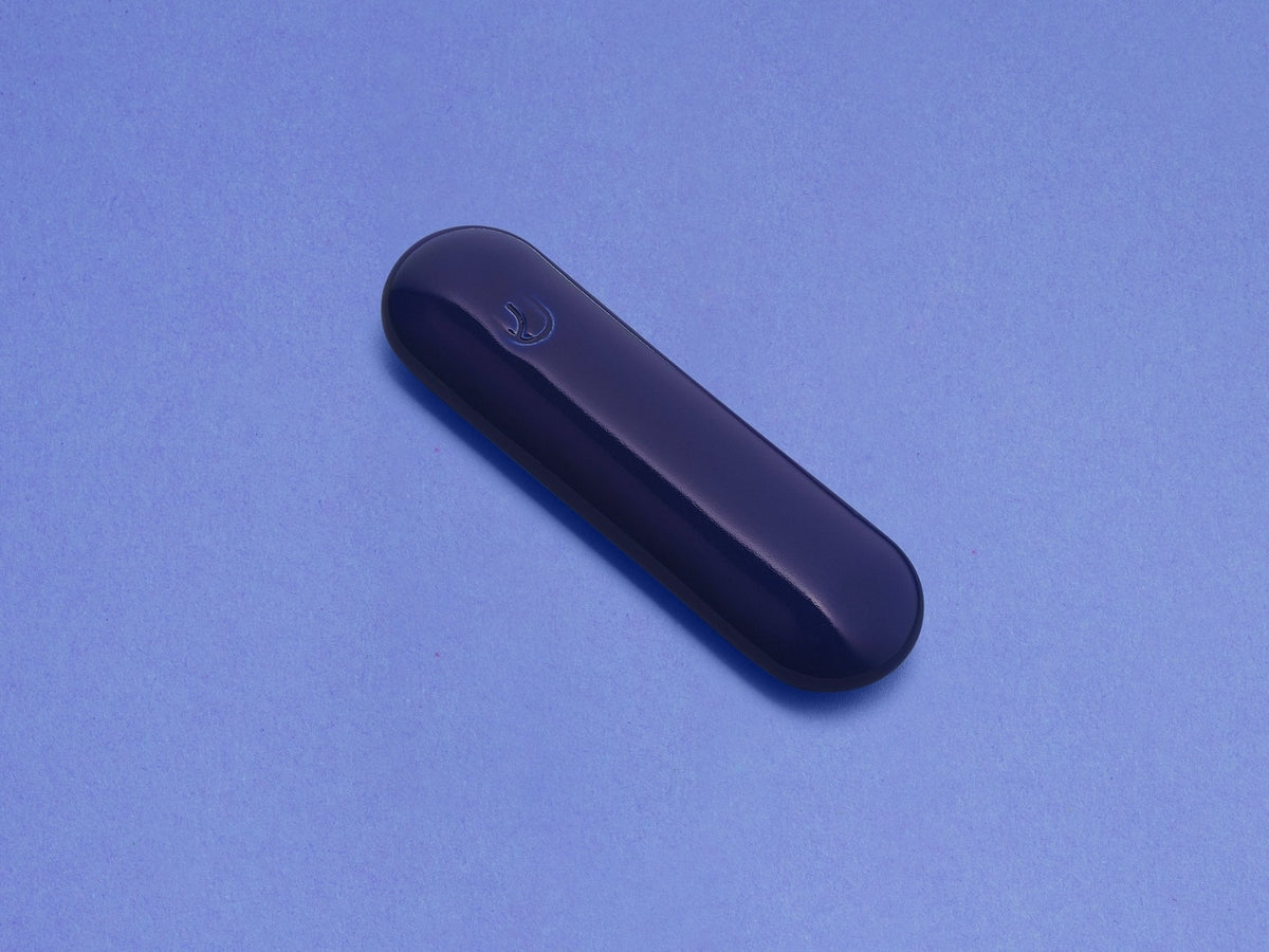 Indigo Ceramic Pill Mezuzah shown at an angle against a blue background