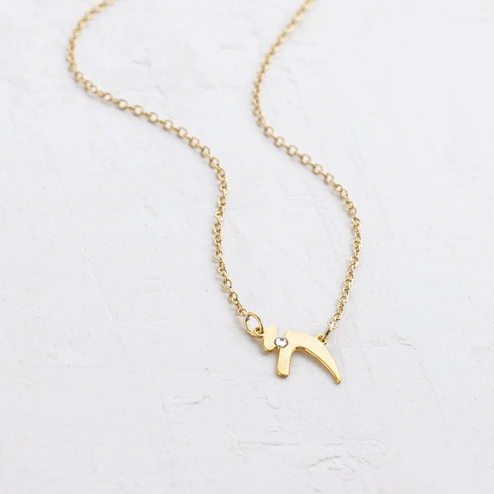 Gold-plated Chai necklace by Shlomit Ofir featuring a delicate Hebrew Chai pendant accented with a clear crystal on a fine gold chain.