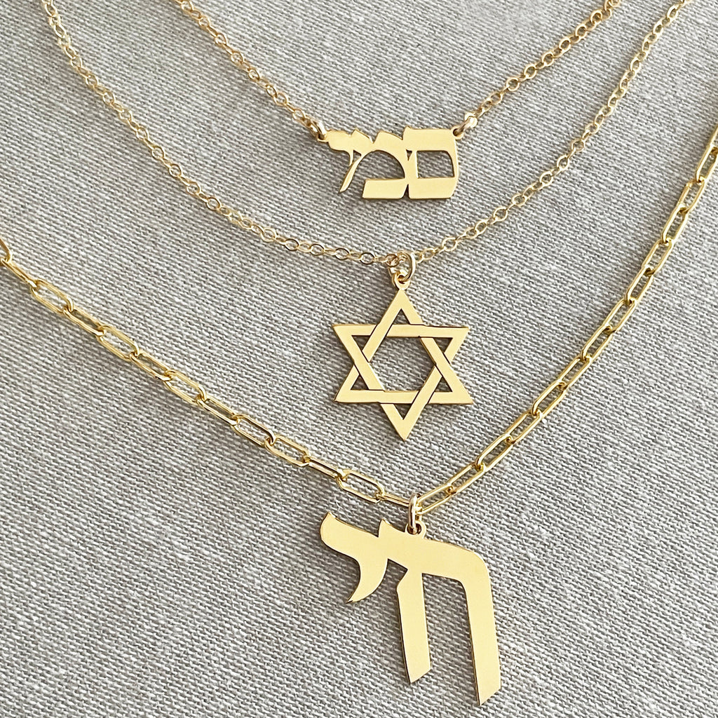 Gold Chai necklace layered with Star of David and Hebrew jewelry