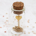 Child Tiny Origami Heart Necklace displayed in a glass gift bottle
