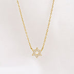 Gold-plated Crystal Set Star of David Necklace by Shlomit Ofir, featuring a petite Magen David pendant with clear crystals on a delicate chain.