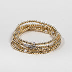 Zoe Lev gold and diamond bead bracelets stacked together