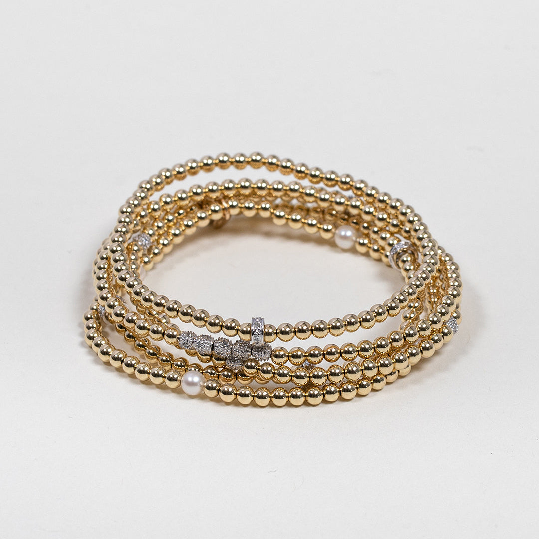 Zoe Lev gold and diamond bead bracelets stacked together