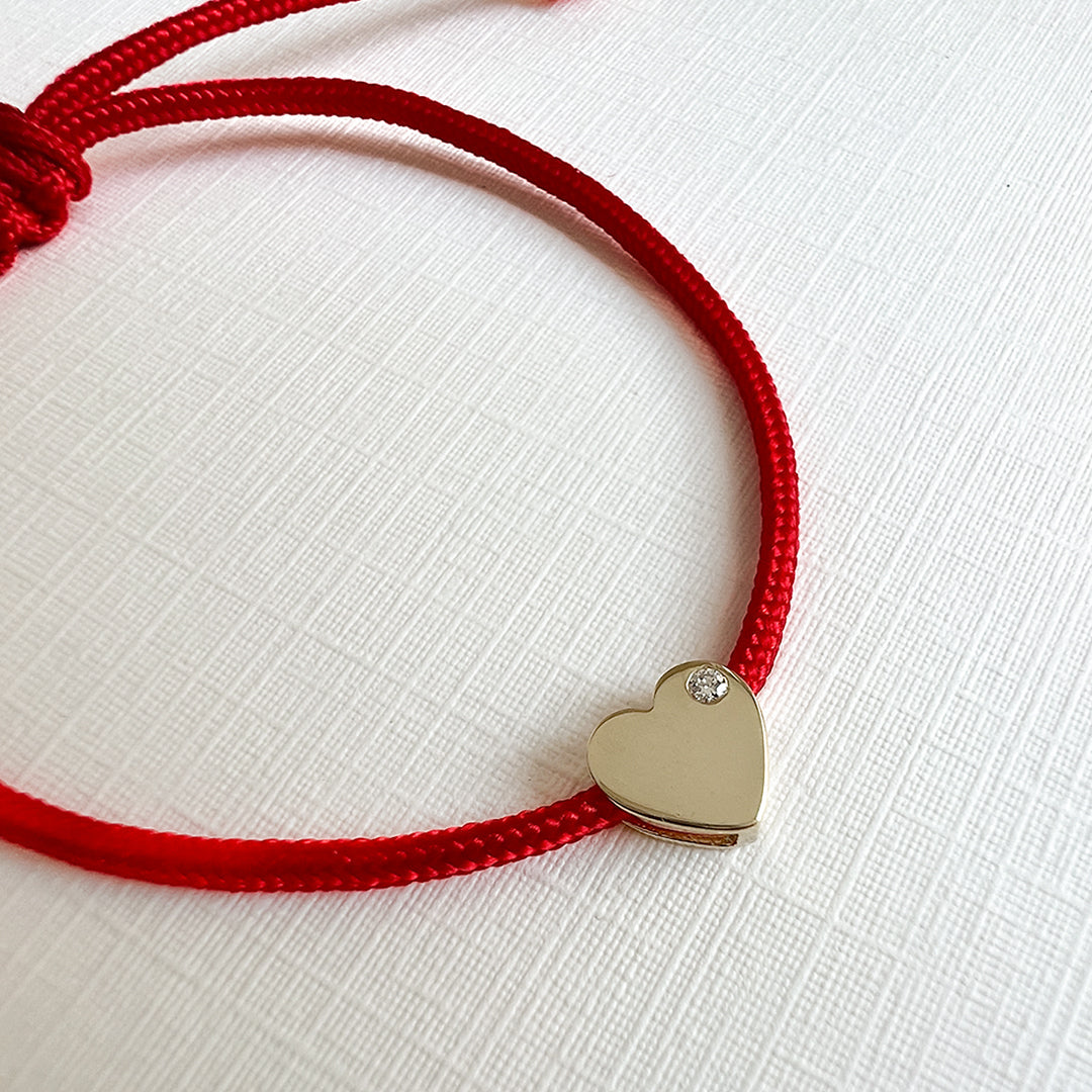 Close-up of 14K gold heart charm on Diamond Heart Fortune Bracelet