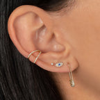 Diamond Mini Evil Eye Stud Earrings worn in a layered ear stack