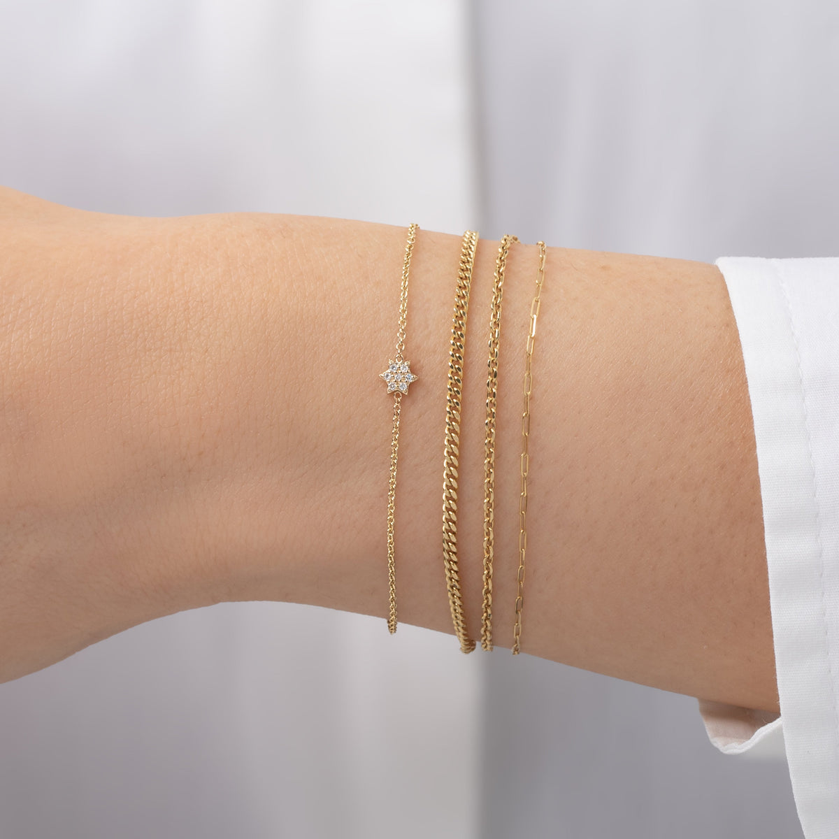 Tiny Diamond Star of David Bracelet worn in a delicate bracelet stack