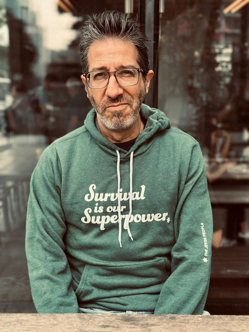 Eitan Chitayat modeling the Survival Is Our Superpower hoodie