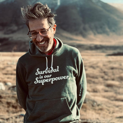 Eitan Chitayat wearing the Survival Is Our Superpower Hoodie in New Zealand
