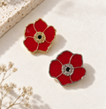 Two red kalanit flower pins with gold and silver-tone details