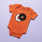 Orange Everything Bagel baby bodysuit by Chunky Deli, product view