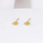 Gold-plated Evie Post Earrings by Shlomit Ofir, featuring delicate eye-shaped studs with clear cubic zirconia accents.