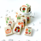 Handcrafted fall mahjong marzipan treats displayed with a mug for an autumn game night