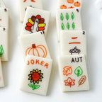 Handcrafted fall marzipan mahjong tiles with pumpkins, leaves, acorns and turkey designs