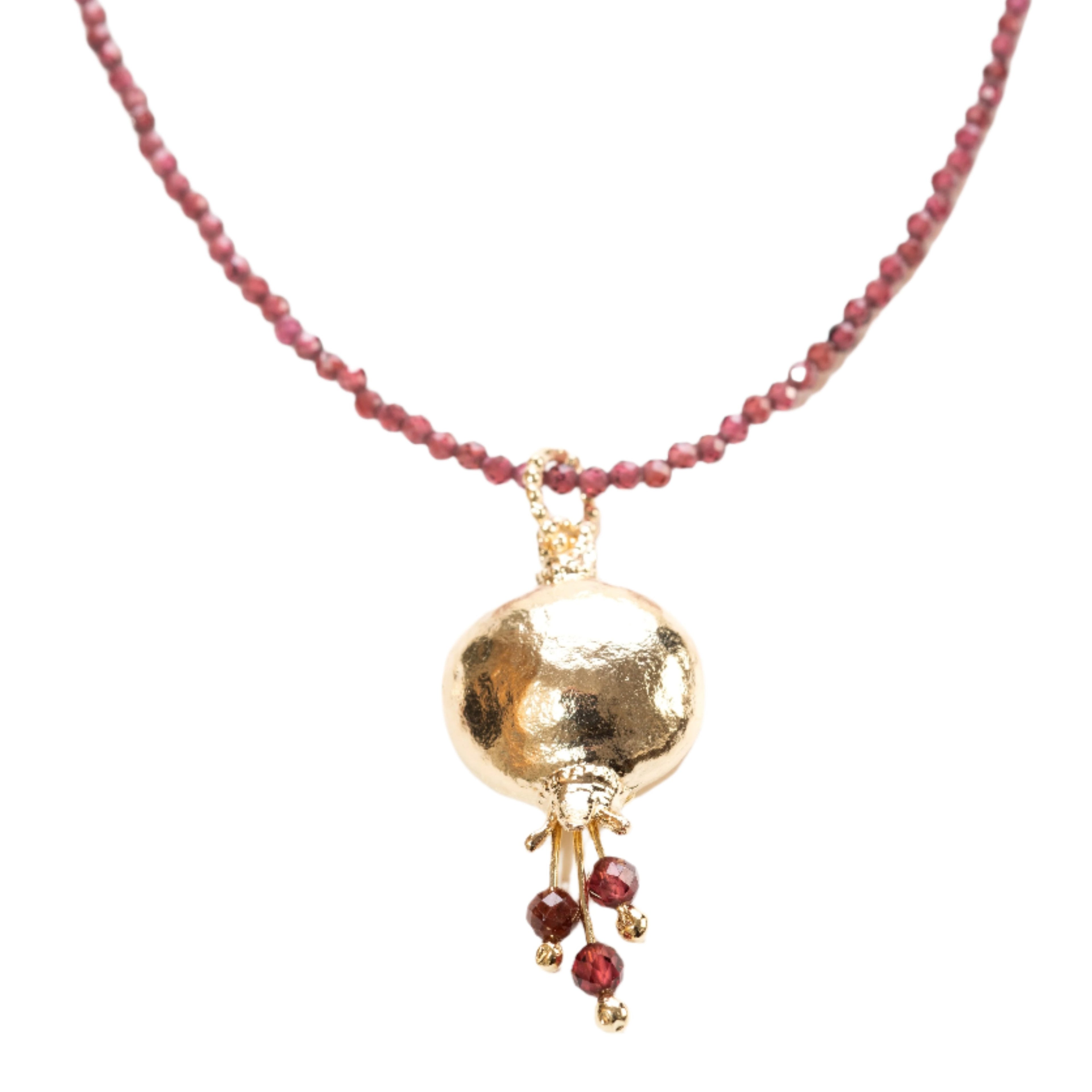 A gold plated pendant necklace with a pomegranate design, featuring red beaded chain and a gold spherical pendant.