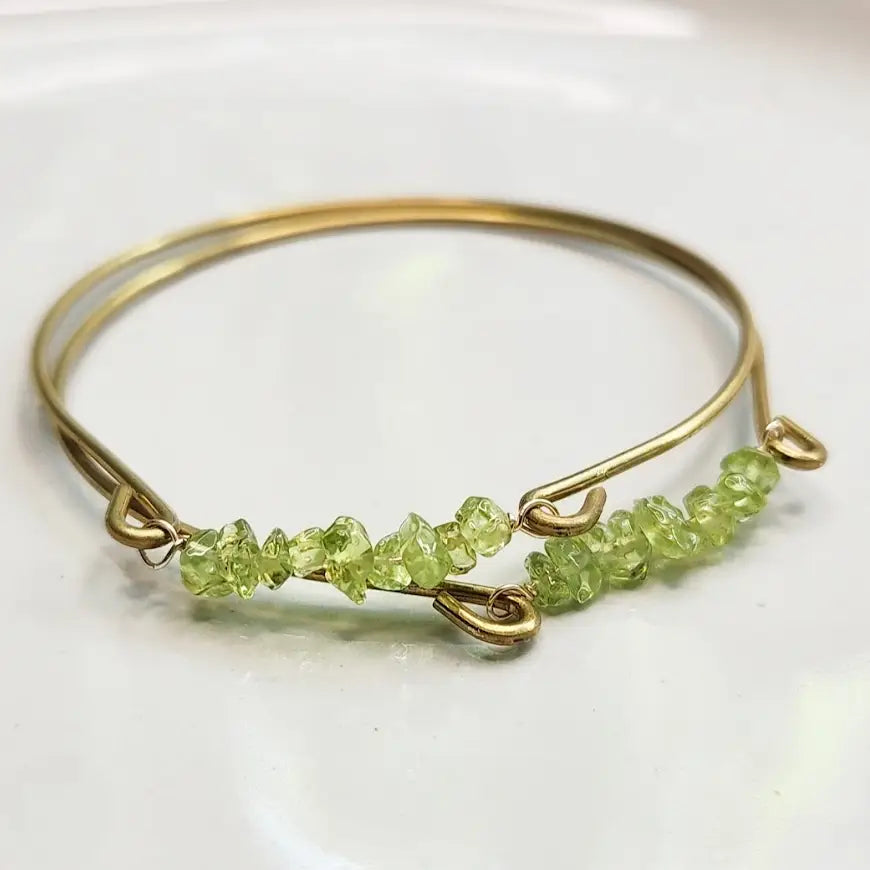 Peridot gemstone and brass bangle by Sara Sela