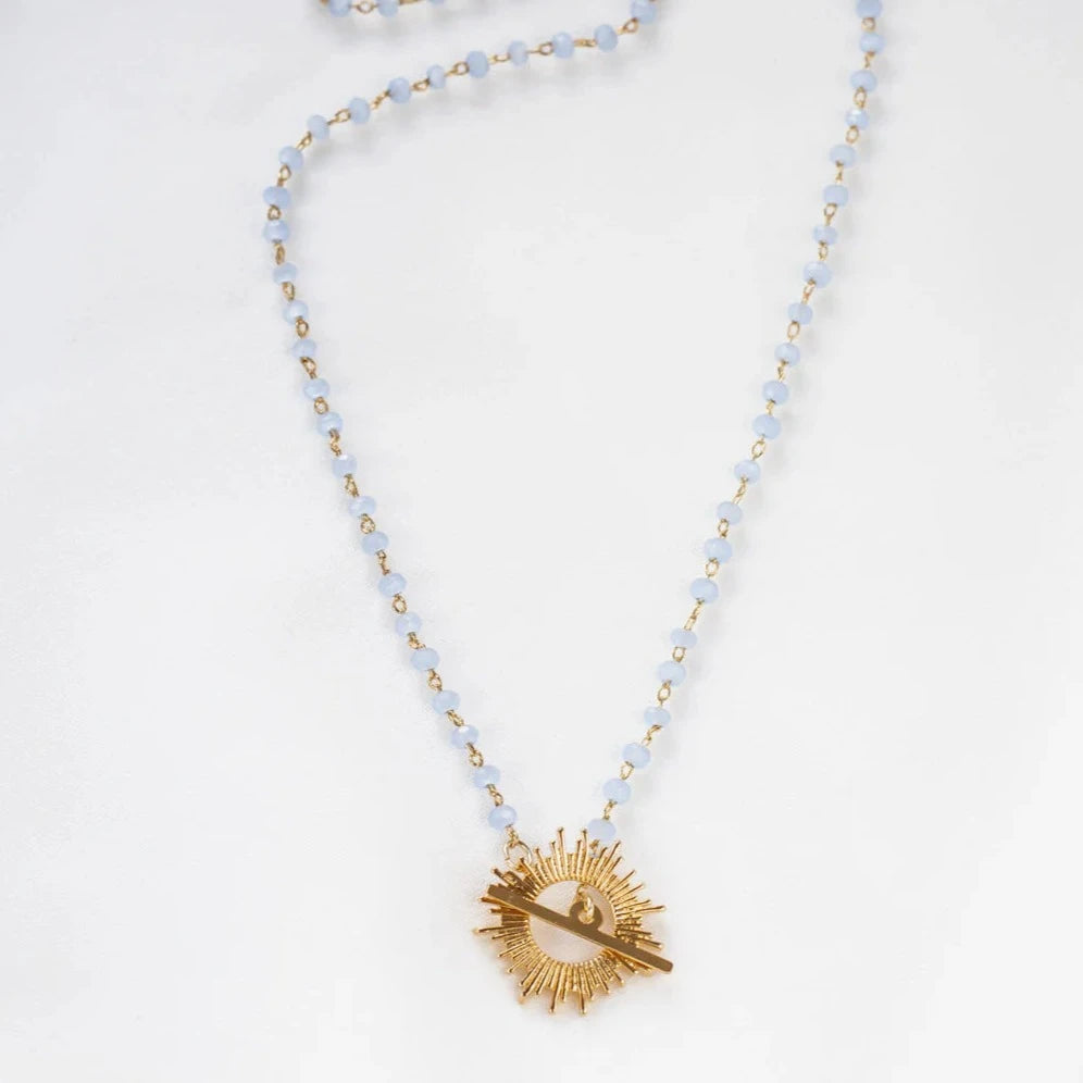 Light blue Glory Necklace with gold starburst pendant by Shlomit Ofir