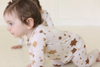 Baby crawling in the Golden Hour Hanukkah Zippy with neutral gold Star of David print.