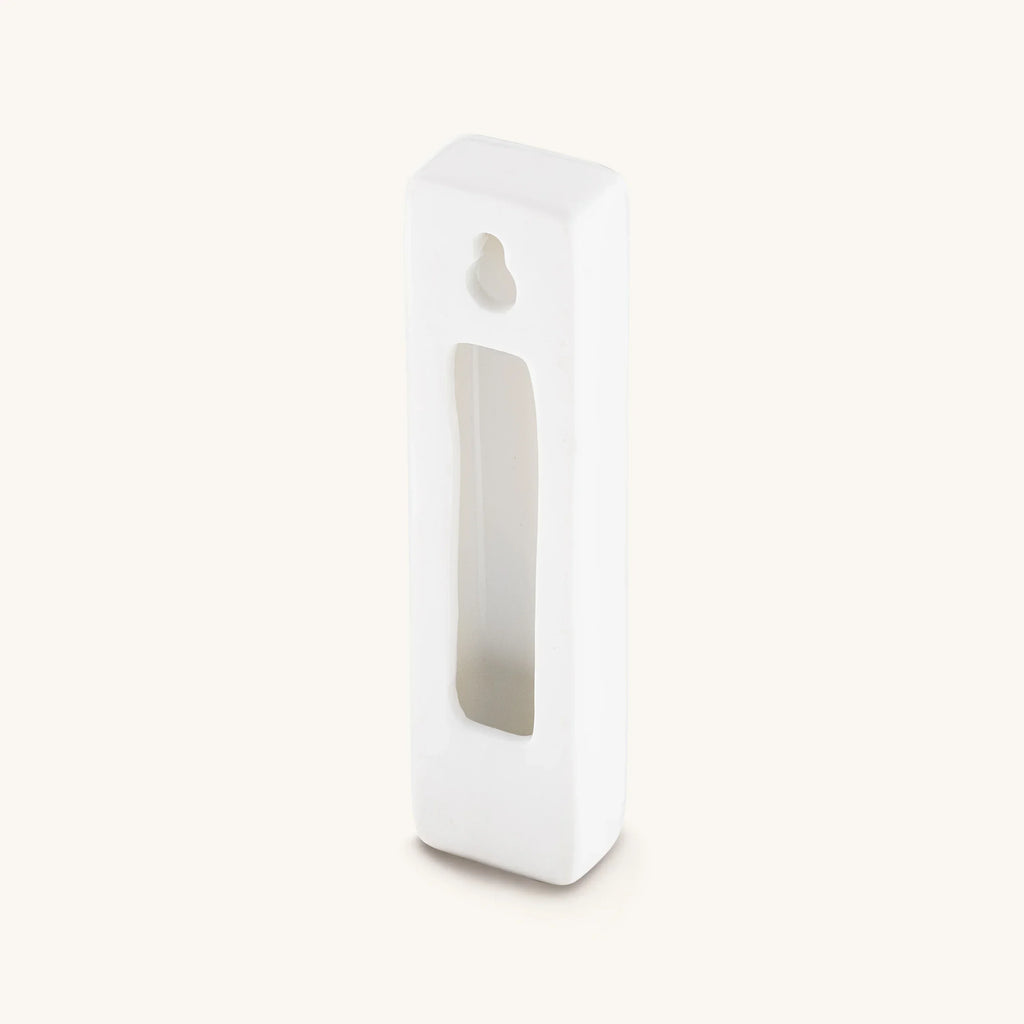 Back of white Grounded Presence ceramic mezuzah case with opening for a scroll