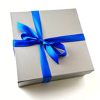 Hanukkah Elegant Gift Box wrapped with a bright blue satin ribbon and bow, ready for gifting.