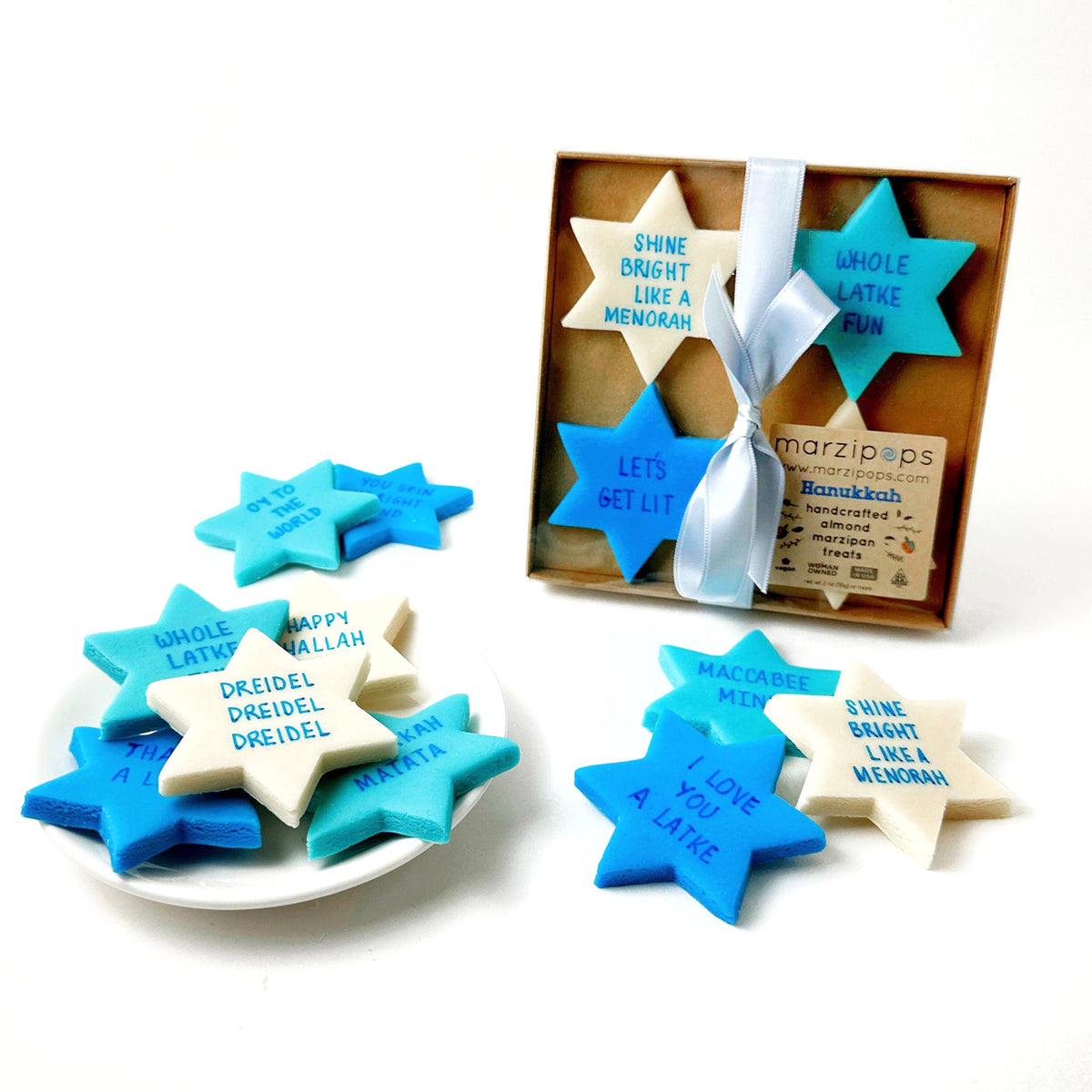 Hanukkah Star of David marzipan conversation tiles in blue, aqua, and cream displayed with their Marzipops gift box.