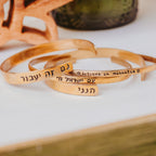 Hand-stamped Hebrew cuff bracelets in gold-tone metals