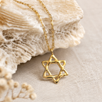 Gold Adi Star of David necklace by Jollori displayed on natural stone
