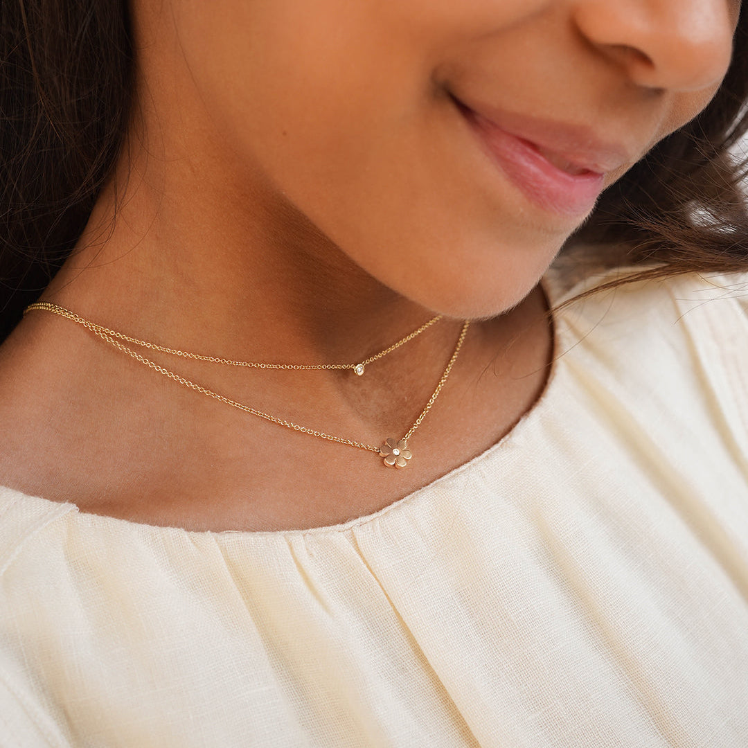 Kids Diamond Flower Necklace worn layered with a delicate gold necklace