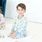 Child wearing the Latkes & Light Hanukkah two-piece set with blue and gold Hanukkah print.