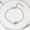 Gold Lenox Evil Eye Bracelet with textured oval and heart center by Shlomit Ofir