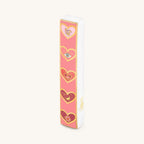 Love Lives Here ceramic heart mezuzah with pink and gold heart designs on white ceramic case