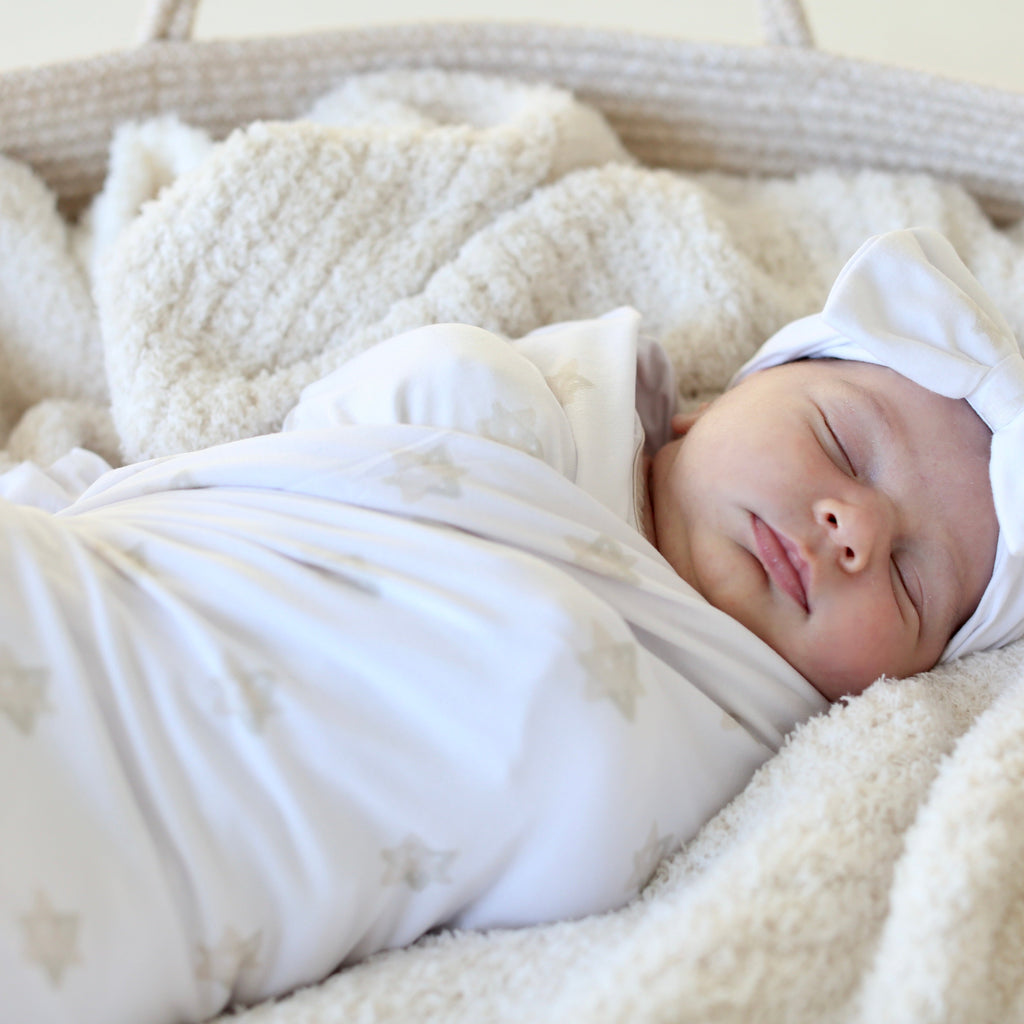 Sleeping newborn wrapped in the Magen Dreams Star of David swaddle by Shiloh & Kate