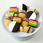 Assorted marzipan Jewish cookies displayed on a glass dessert stand