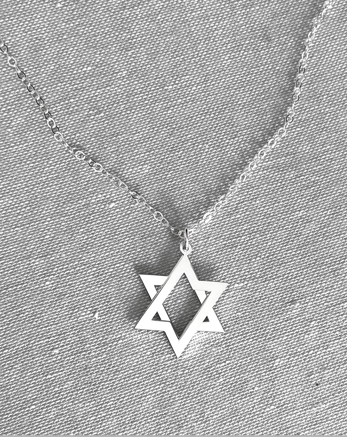 Close-up of interlocking stars on sterling silver Movable Star of David Necklace