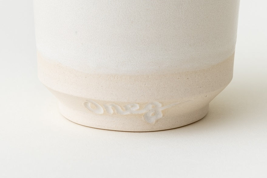 Detail of Oneg maker's mark on white ceramic Kiddush cup