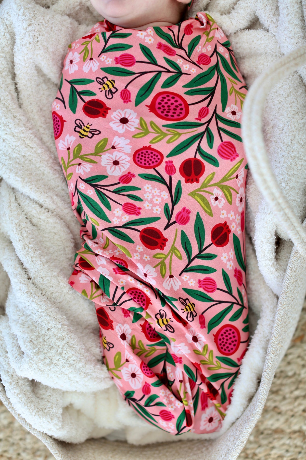 Close view of newborn wrapped in the Petals & Pomegranates bamboo swaddle by Shiloh & Kate