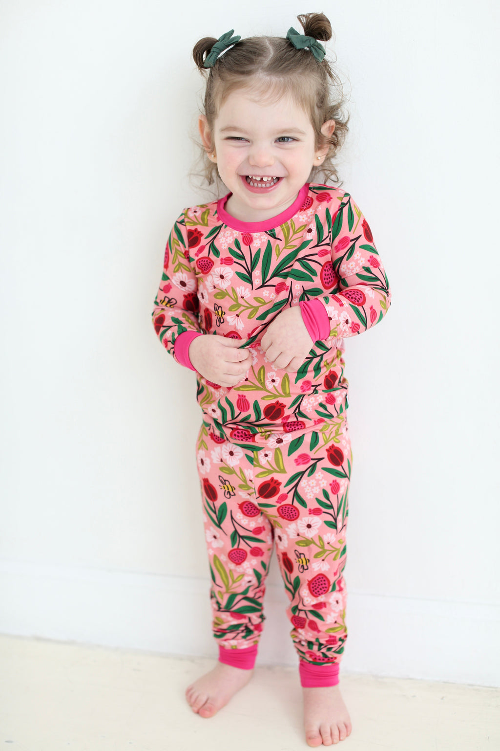 Full-length view of a child wearing the Petals & Pomegranates bamboo pajama set