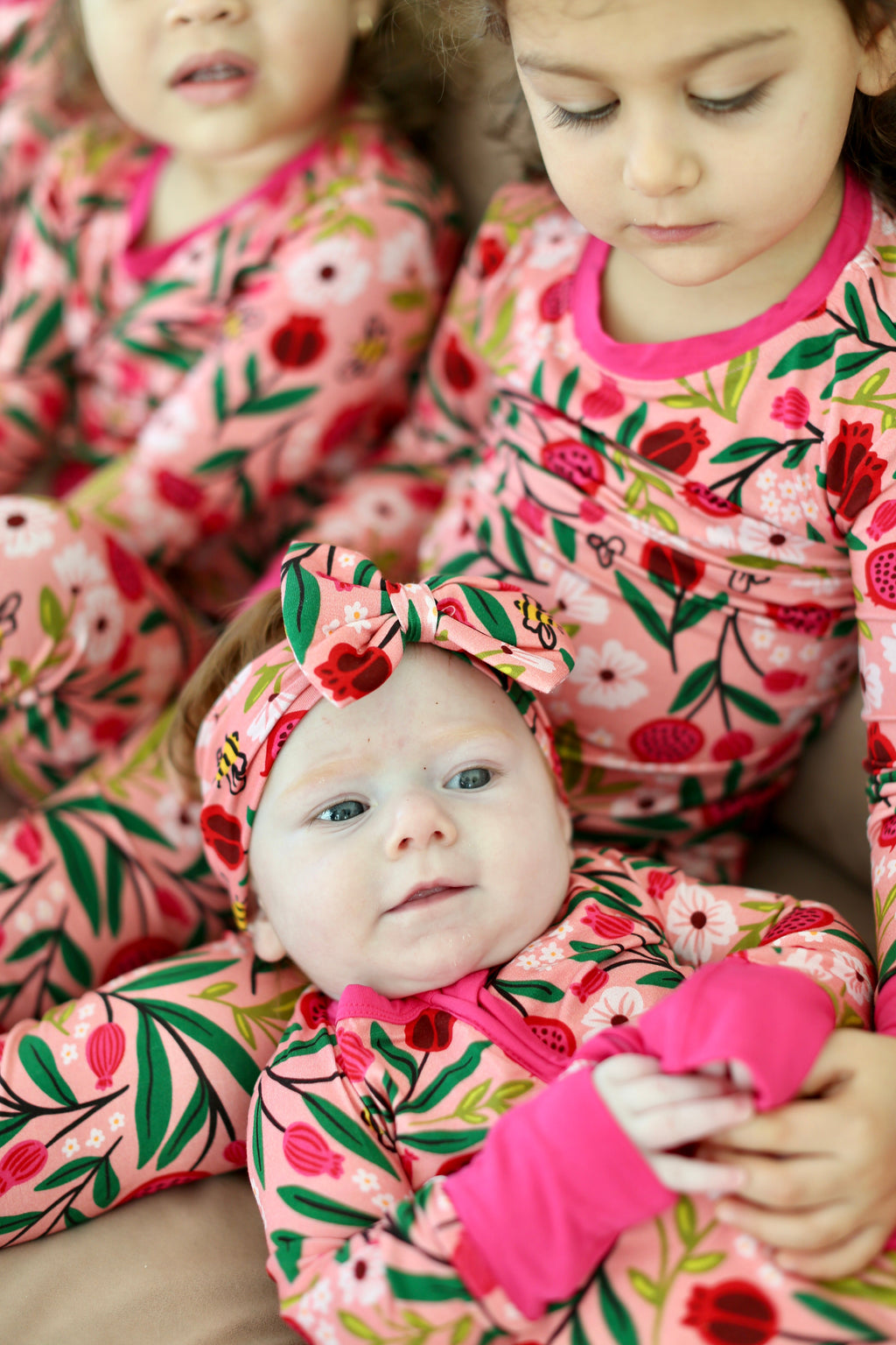 Baby in the Petals & Pomegranates zippy surrounded by children in matching pajamas