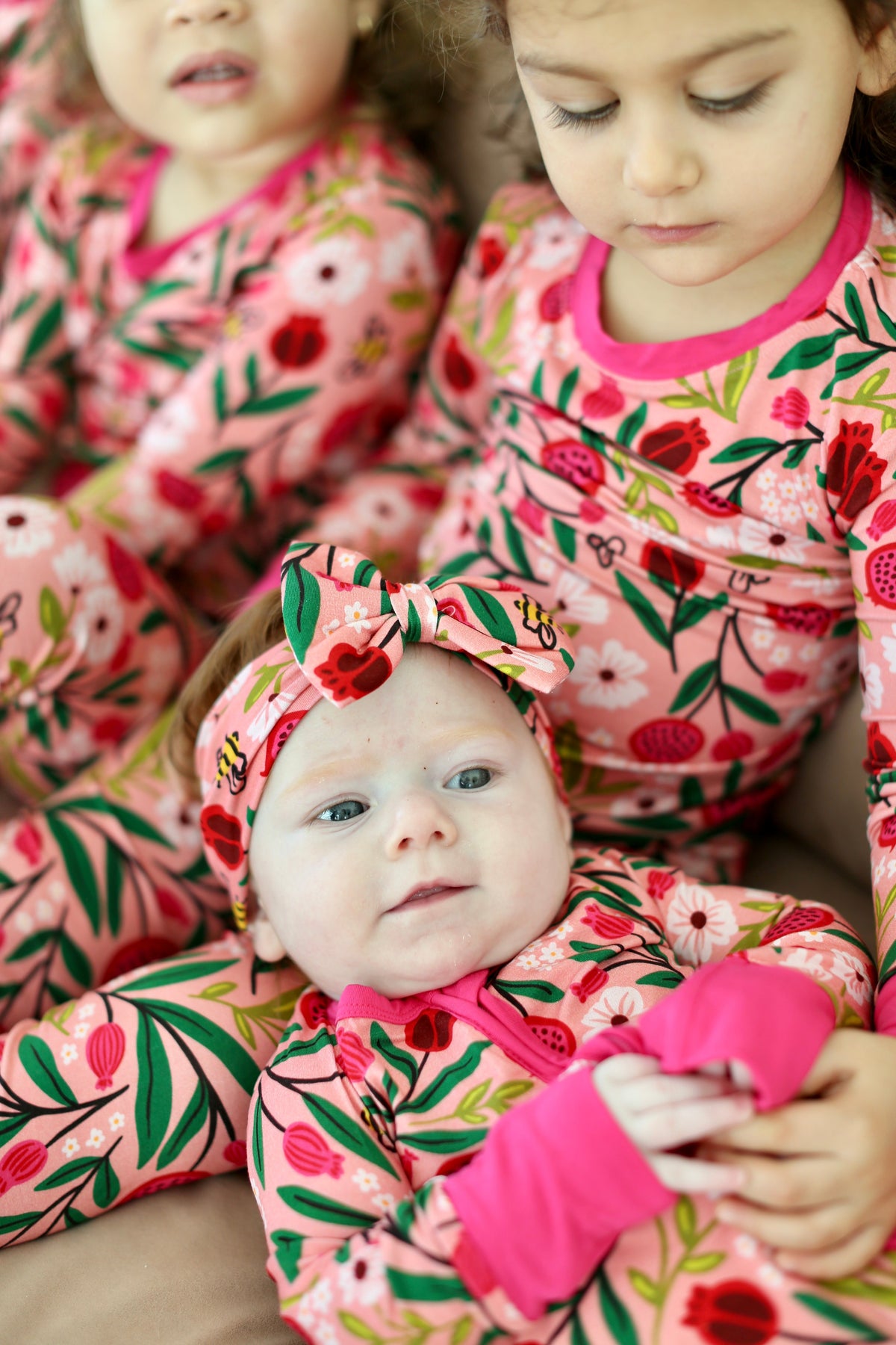 Baby in the Petals & Pomegranates zippy surrounded by children in matching pajamas